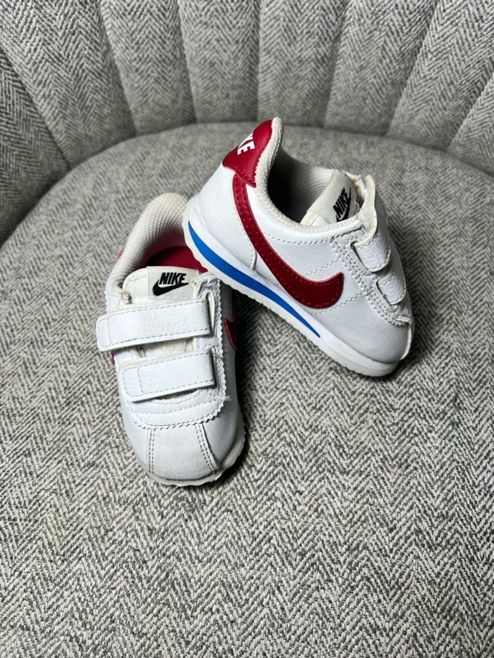 Nike White Baby Sneakers with Red Swoosh and Blue Accent